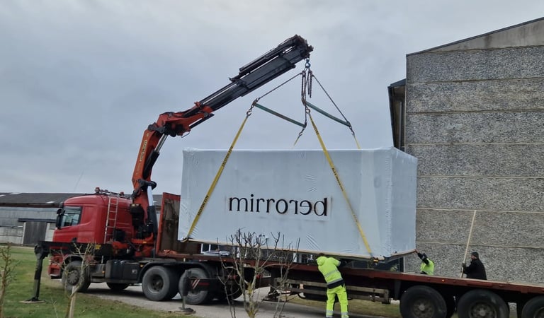Mirrored Cabin transported on a truck trailer