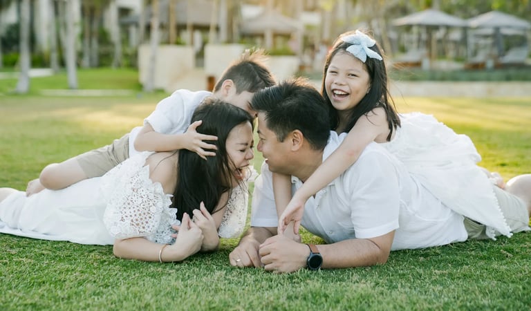 Natural family lifestyle photography on the Ocean Lawn at The Apurva Kempinski Bali