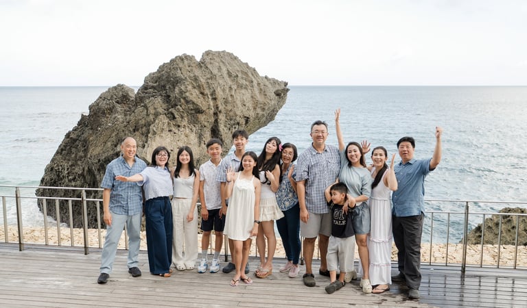 Extended family enjoying a candid joyful moment together during a sunset session at Ayana Jimbaran Bali