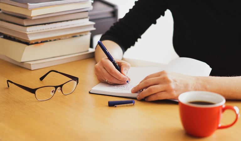 <a href="https://www.freepik.com/free-photo/closeup-shot-woman-working-studying-from-home-with-red-c