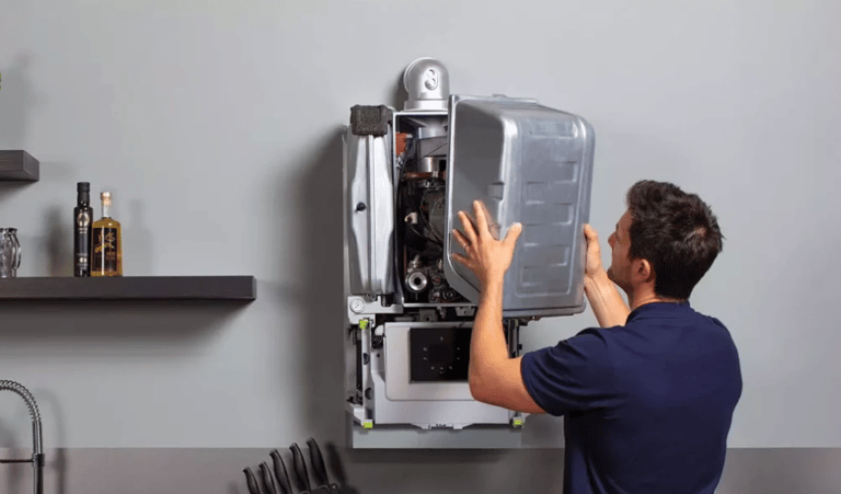 a man is fixing a refrigerator in a kitchen