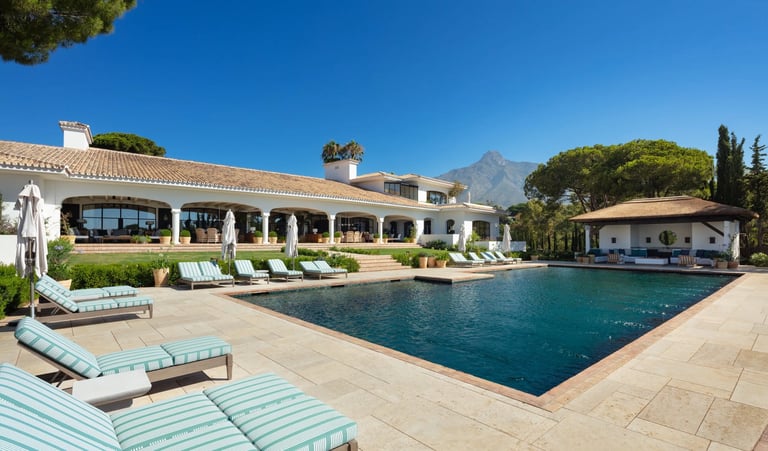 Main pool at Villa La Gratitud with sunbeds and Mediterranean backdrop