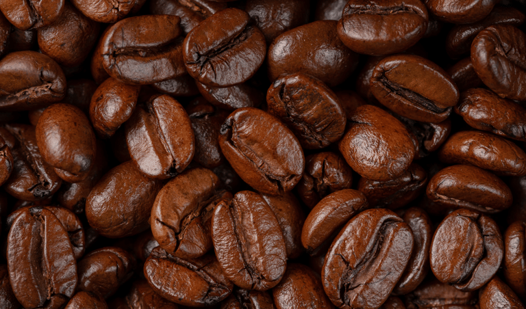 a close up of a pile of dark roast coffee beans