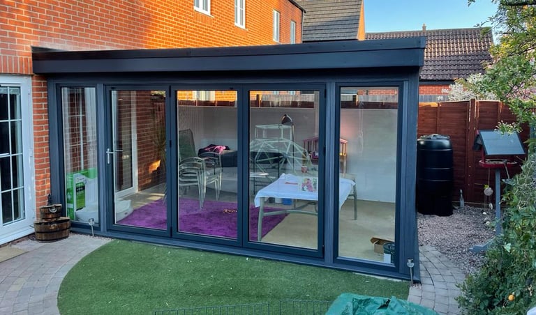 Composite wood extension with bi-folding doors