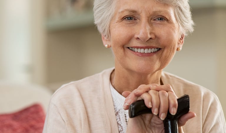 A smiling woman with dentures.