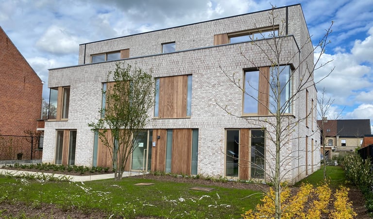 a house with a brick wall and a sign that says,