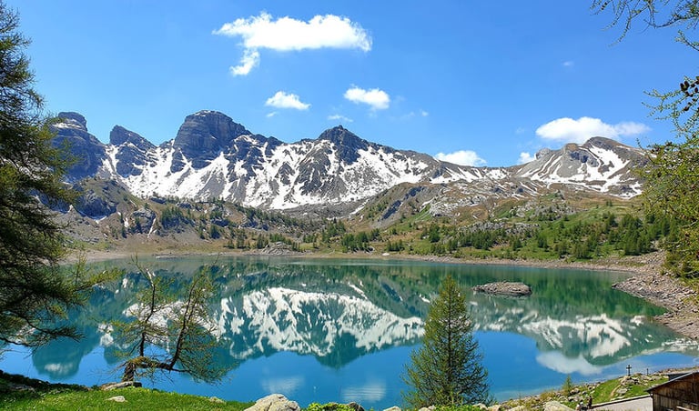 Alps mountain lake with mountains and snow