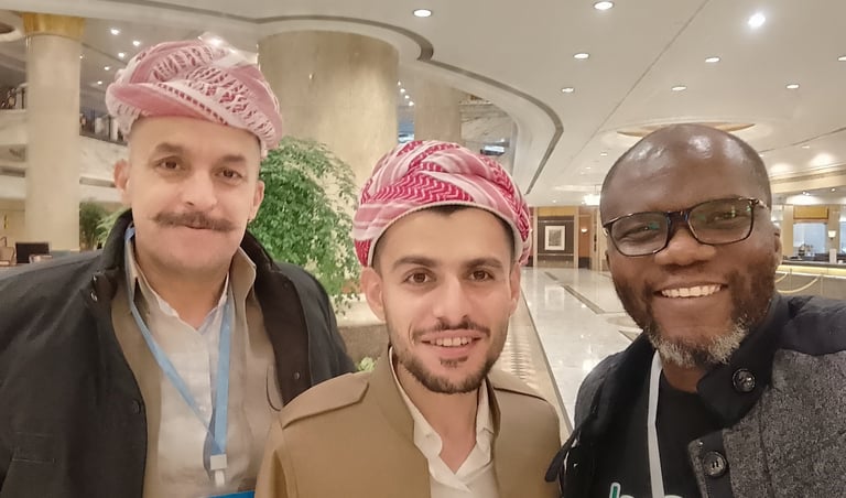 three men standing next to each other in a lobby