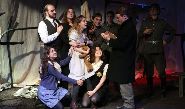 Ensemble during the "Red Cross Visit" scene