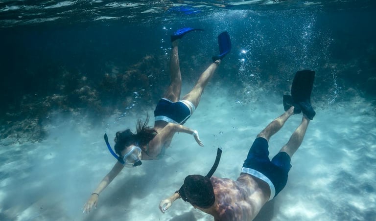 two people happily freediving