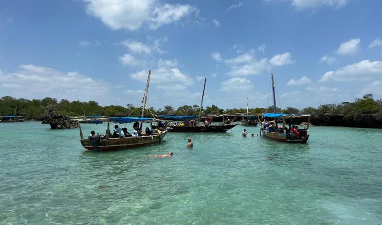 Local tour guide welcoming tourists on Safari Blue Zanzibar boat tour, guiding snorkeling and marine life experience