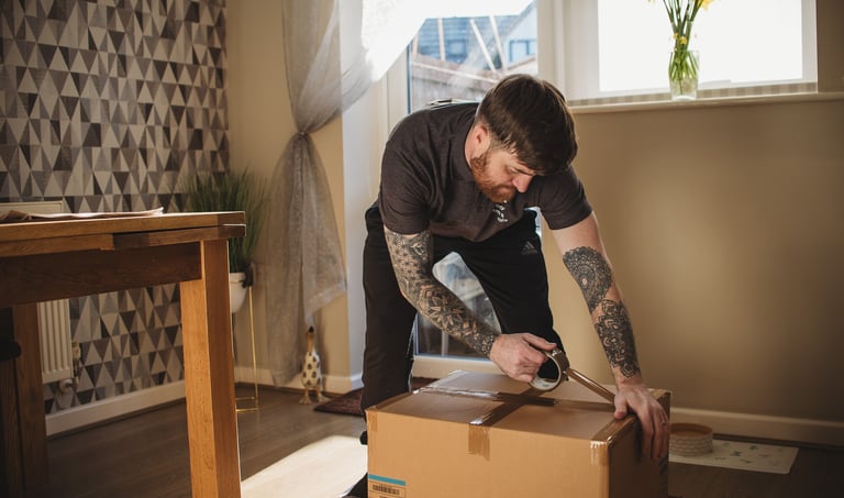 deanos removals tapping a box in a worcester home