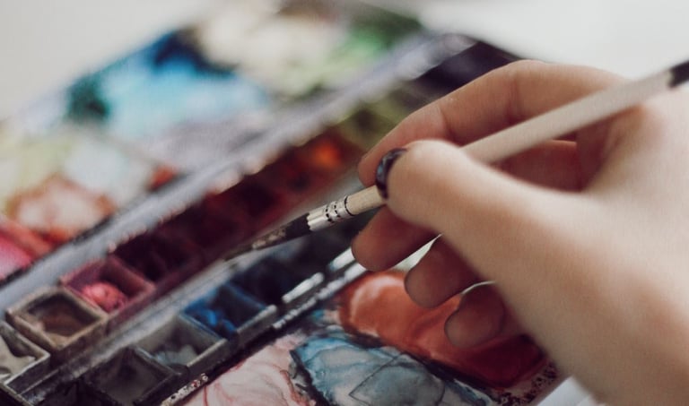 a person holding a paintbrush and a paintbrush in their hand