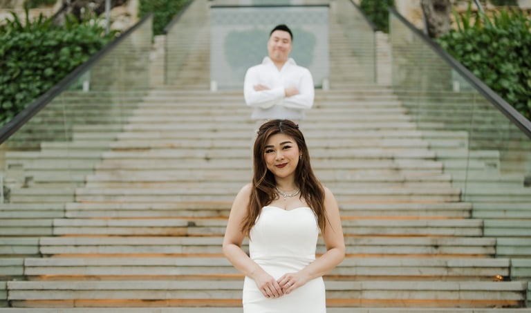 Elegant portrait of a couple on the grand staircase during a prewedding photoshoot at Apurva Kempinski Bali