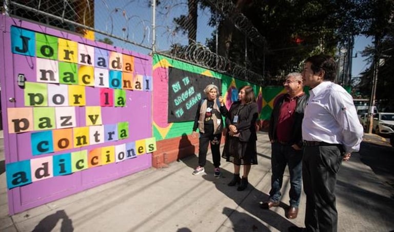 a group of people standing around a fence