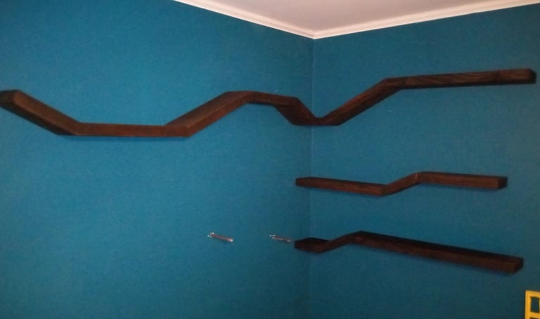 Four floating shelves mounted on wall