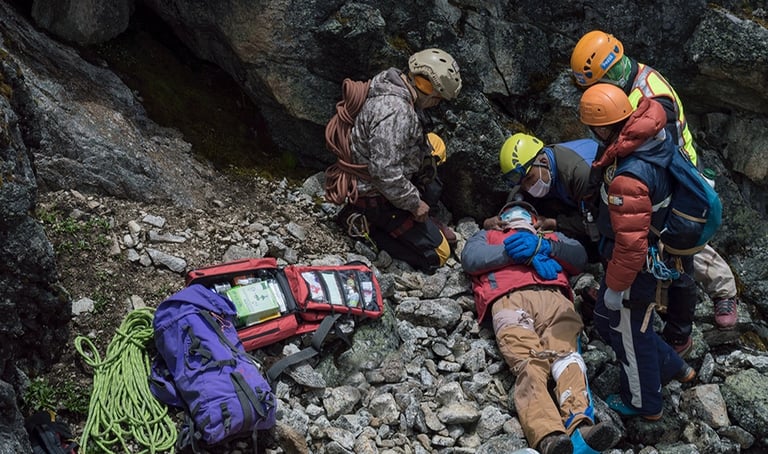 rescuers saving injured on mountain