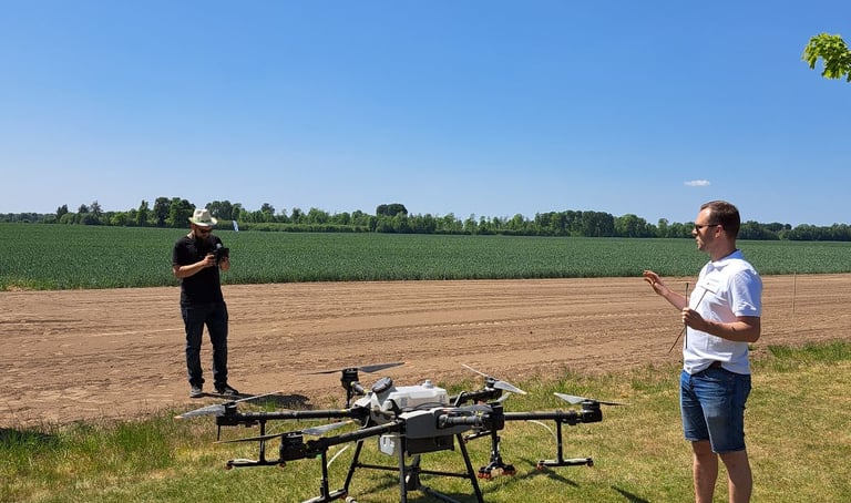 standing in a field with a remote and a drone