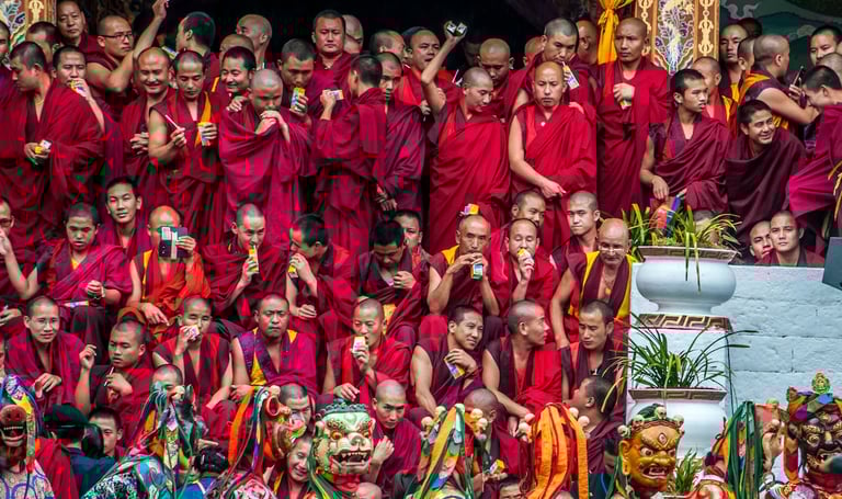 Masked-dancer-with-Monks-in-The-Backdrop-in-Thimphu