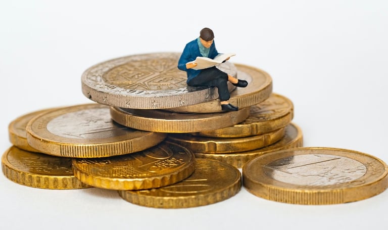 a miniature figurine of a man sitting on top of a pile of coins
