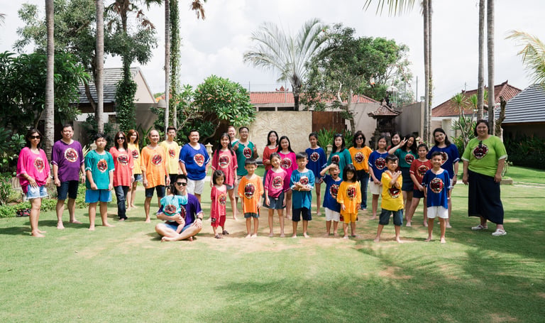 Extended family group portrait at Lumbini Villas Jimbaran Bali with multiple generations in a tropical garden setting