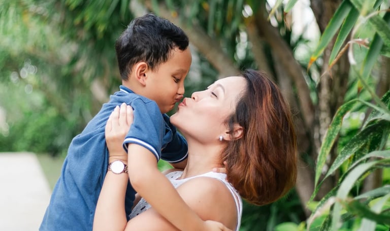 Parents embracing with child during garden session at The Mulia Nusa Dua Bali