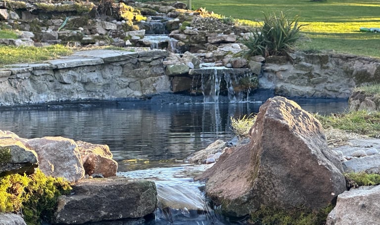 Custom made waterfall water feature through 3 tear stacked ponds from big waterfall