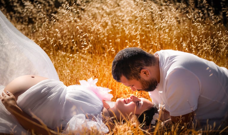 a man and woman in white wedding dress laying on the ground