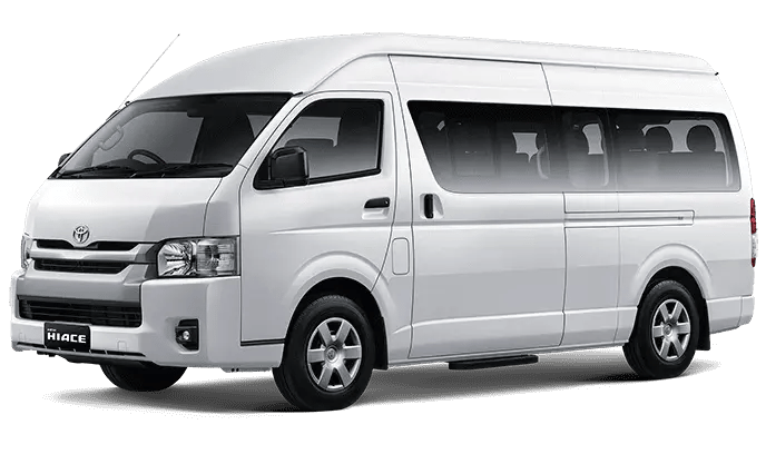 Toyota Hiace warna putih dengan pintu geser menggunakan velg silver.