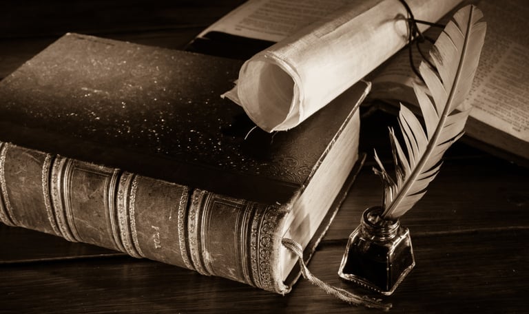 old book, scroll and quill pen