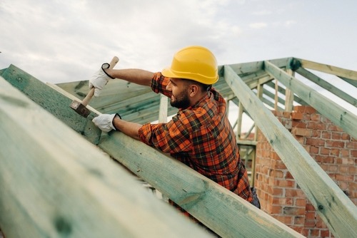 a man in a hard hat working on a roof