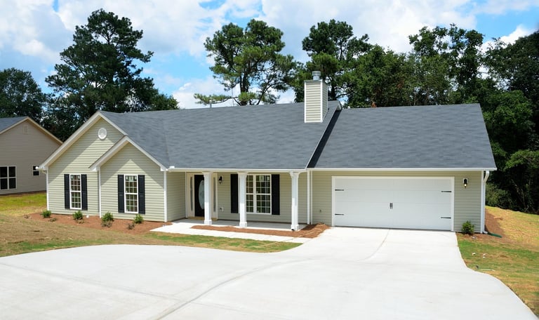 a house with a garage door and a driveway