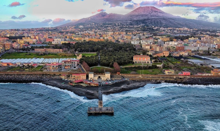 Mt. Veruvius behind homes and coastline in Naples Italy
