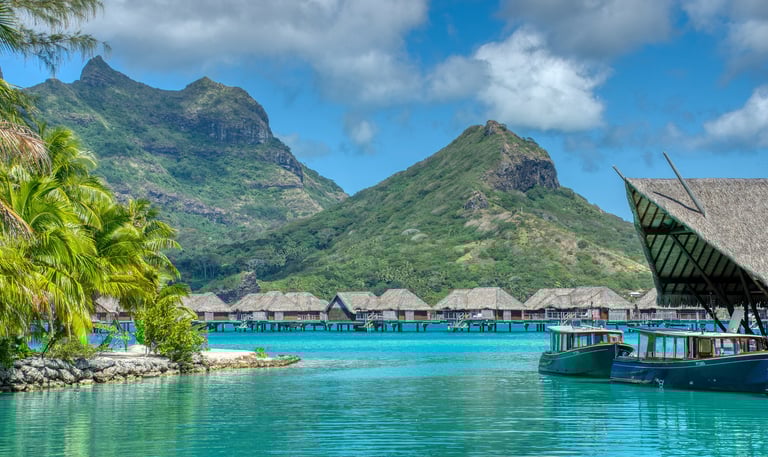 tahiti water with bungalows and mountains