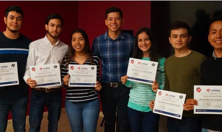 a group of people standing around a table with certificates
