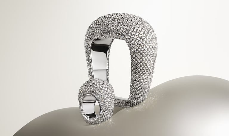 Cartier diamond-encrusted statement ring and bracelet with unique architecture.