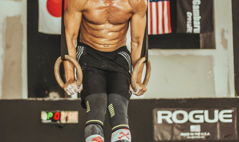 a man doing a pull up barbell in a gym