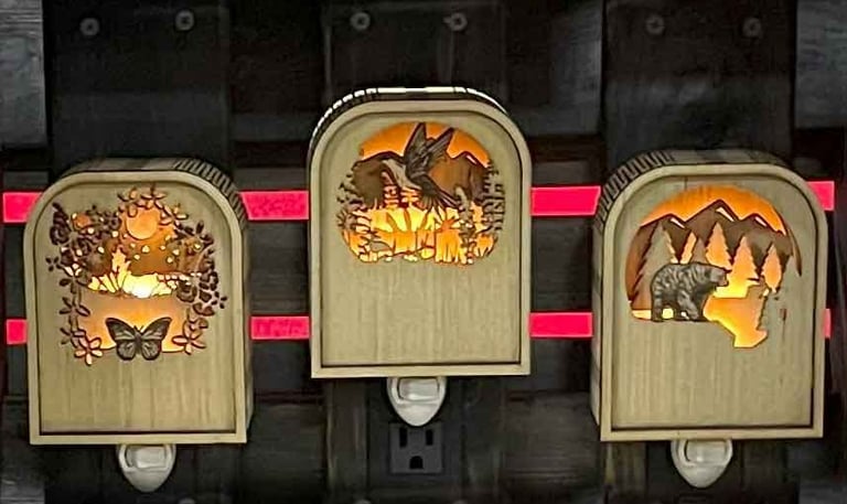 three decorative wooden carved nightlights