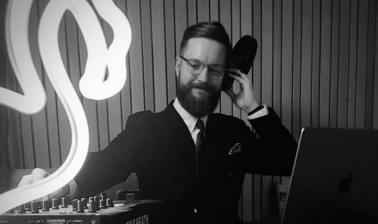 a man in a suit and tie. DJ.