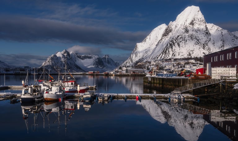 Sailboats in harbor infront of Fjords Lofoten Norway