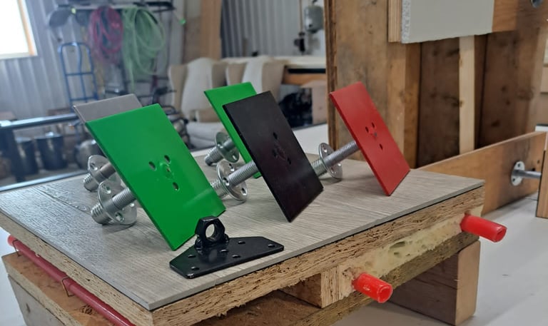 Mounted color-coded anchor plates displayed on a construction test setup for framing and insulation systems