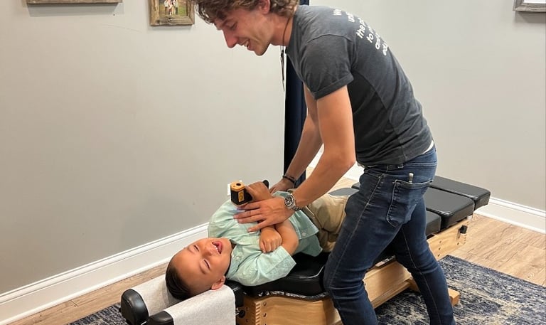 Child receiving chiropractic adjustment for sensory processing issues