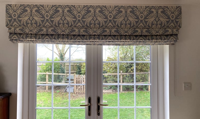 A large blind with a solid fabric in the same fabric which is carefully pattern matched