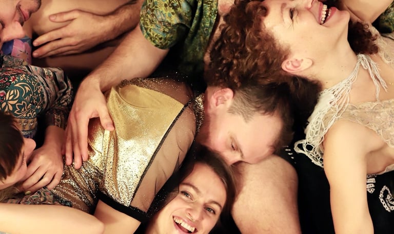 a group of people laying on the floor in a cuddle puddle