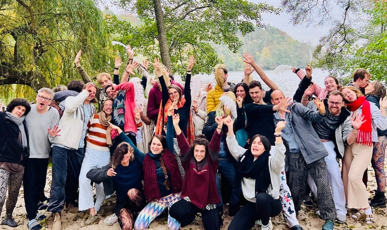 a group of people standing around a lake