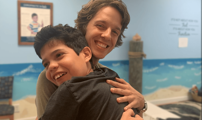 Chiropractor working with special needs to help with speech and motor delays