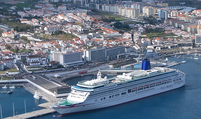 Cruise Ship in the Port of Ponta Delgada with mountains and buildings in distance