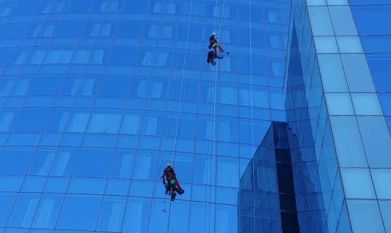 a man is hanging from a high riser