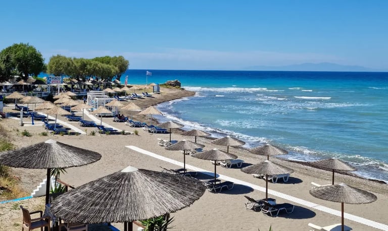 a beach with umbrellas and umbrellas on the beach