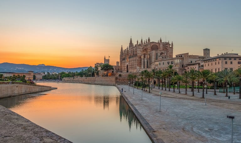 Palma De Mallorca famous building Infront of water with mountain in distance